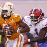 Tennessee quarterback Hendon Hooker (5) runs for yardage while pursued by Florida linebacker Brenton Cox Jr. (1) during the first half of an NCAA college football game Saturday, Sept. 24, 2022, in Knoxville, Tenn. (AP Photo/Wade Payne)