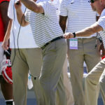 Georgia head coach Kirby Smart, left, is pulled off the field by an assistant coach as he yells to his players in the first half of an NCAA college football game against Kent State Saturday, Sept. 24, 2022, in Athens, Ga. (AP Photo/John Bazemore)
