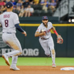 Cleveland Guardians shortstop Amed Rosario, right, tosses the ball to third baseman Gabriel Arias for an out during the fourth inning of a baseball game against the Texas Rangers in Arlington, Texas on Sunday, Sept. 25, 2022. (AP Photo/Gareth Patterson)