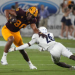 Arizona State tight end Messiah Swinson (80) avoids the tackle attempt by Northern Arizona defensive back Colby Humphrey during the first half of an NCAA college football game Thursday, Sept. 1, 2022, in Tempe, Ariz. (AP Photo/Rick Scuteri)
