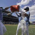 
              Kansas City Royals' Michael Massey, right, is doused by MJ Melendez and Bobby Witt Jr., left, after their baseball game against the Detroit Tigers Sunday, Sept. 11, 2022, in Kansas City, Mo. The Royals won 4-0. (AP Photo/Charlie Riedel)
            