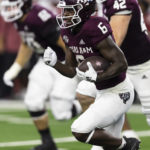
              Texas A&M running back Devon Achane (6) carries the ball during the first half of the team's NCAA college football game against Arkansas on Saturday, Sept. 24, 2022, in Arlington, Texas. (AP Photo/Brandon Wade)
            
