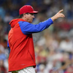 FILE - Philadelphia Phillies interim manager Rob Thomson points to the bullpen during a baseball game against the Atlanta Braves, Wednesday, June 29, 2022, in Philadelphia. Thomson has led his team to the brink of the playoffs. The Phillies' magic number is eight as they open a 10-game road trip Tuesday at Wrigley Field. If the Phillies keep their third wild-card spot, it's off to St. Louis for a best-of-three series played all in Missouri. (AP Photo/Matt Slocum, File)