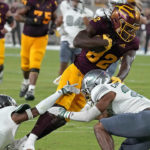 Arizona State's Andre Johnson (82) fights for extra yardage against Eastern Michigan's Joshua Scott (15) and David Carter Jr. (27) during the first half of an NCAA college football game Saturday, Sept. 17, 2022, in Tempe, Ariz. (AP Photo/Darryl Webb)