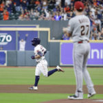 Houston Astros' Jose Altuve, left, head to second base on his home run off of Arizona Diamondbacks starting pitcher Zach Davies (27), as he looks on from the mound during the first inning of a baseball game Tuesday, Sept. 27, 2022, in Houston. (AP Photo/Michael Wyke)