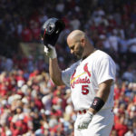 St. Louis Cardinals' Albert Pujols heads back to the dugout after flying out during the fourth inning of a baseball game against the Cincinnati Reds Sunday, Sept. 18, 2022, in St. Louis. (AP Photo/Jeff Roberson)