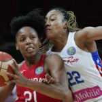 Canada's Nirra Fields, left, attempts to get past Puerto Rico's Arella Guirantes during their quarterfinal game at the women's Basketball World Cup in Sydney, Australia, Thursday, Sept. 29, 2022. (AP Photo/Mark Baker)