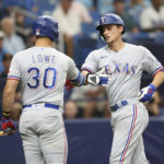 Texas Rangers' Corey Seager, right, celebrates with teammate Nathaniel Lowe (30) after hitting a home run against the Tampa Bay Rays during the fith inning of a baseball game, Sunday, Sept. 18, 2022, in St. Petersburg, Fla. (AP Photo/Mark LoMoglio)