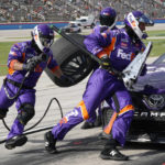 
              Denny Hamlin's pit crew change tires during the NASCAR Cup Series auto race at Texas Motor Speedway in Fort Worth, Texas, Sunday, Sept. 25, 2022. (AP Photo/Larry Papke)
            