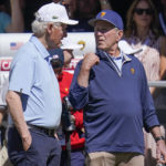 Former President's Bill Clinton, left and George W. Bush speak on the first tee during a fourball match at the Presidents Cup golf tournament at the Quail Hollow Club, Friday, Sept. 23, 2022, in Charlotte, N.C. (AP Photo/Julio Cortez)