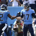 Tennessee Titans quarterback Ryan Tannehill (17) celebrates with Robert Woods (2) after Tannehill ran for a touchdown against the Las Vegas Raiders in the first half of an NFL football game Sunday, Sept. 25, 2022, in Nashville, Tenn. (AP Photo/Mark Zaleski)