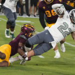 Eastern Michigan running back Evans Sampson (22) gets wrapped up by Arizona State's Jordan Clark (1) during the first half of an NCAA college football game Saturday, Sept. 17, 2022, in Tempe, Ariz. (AP Photo/Darryl Webb)