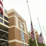 American flags fly at half-staff outside Boone Pickens Stadium prior to an NCAA college football game between Oklahoma State and Arizona State, Saturday, Sept. 10, 2022, in Stillwater, Okla. (AP Photo/Brody Schmidt)