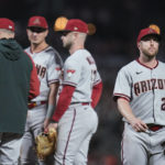 Arizona Diamondbacks starting pitcher Merrill Kelly, right, is pulled from the baseball game against the San Francisco Giants during the fifth inning in San Francisco, Friday, Sept. 30, 2022. (AP Photo/Godofredo A. Vásquez)