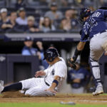 New York Yankees' Oswald Peraza scores a run past Tampa Bay Rays catcher Christian Bethancourt during the seventh inning of a baseball game Friday, Sept. 9, 2022, in New York. (AP Photo/Adam Hunger)