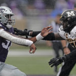 Kansas State defensive end Felix Anudike-Uzomah, left, and Missouri offensive lineman Javon Foster, right, block each other during the first half of an NCAA college football game Saturday, Sept. 10, 2022, in Manhattan, Kan. (AP Photo/Charlie Riedel)