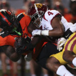
              Oregon State running back Jam Griffin is brought down by Southern California defensive back Max Williams during the first half of an NCAA college football game Saturday, Sept. 24, 2022, in Corvallis, Ore. (AP Photo/Amanda Loman)
            