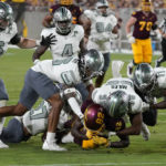 Eastern Michigan's defense smothers Arizona State's Andre Johnson (82) during the first half of an NCAA college football game Saturday, Sept. 17, 2022, in Tempe, Ariz. (AP Photo/Darryl Webb)