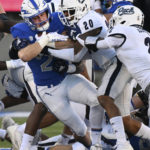 Air Force running back Brad Roberts, left, runs for a gain as Nevada defensive back Bentlee Sanders (20) brings him down during the first quarter of an NCAA college football game Friday, Sept. 23, 2022, in Air Force Academy, Colo. (Christian Murdock/The Gazette via AP)