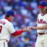 
              Philadelphia Phillies starting pitcher Bailey Falter, right, hands the ball off to manager Rob Thomson, left, as he is pulled during the fourth inning of a baseball game against the Atlanta Braves, Saturday, Sept. 24, 2022, in Philadelphia. (AP Photo/Chris Szagola)
            
