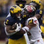 
              Michigan running back Blake Corum (2) is tackled by Maryland defensive back Beau Brade (25) in the first half of an NCAA college football game in Ann Arbor, Mich., Saturday, Sept. 24, 2022. (AP Photo/Paul Sancya)
            