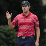 Patrick Cantlay waves after his birdie putt on the third green during their singles match at the Presidents Cup golf tournament at the Quail Hollow Club, Sunday, Sept. 25, 2022, in Charlotte, N.C. (AP Photo/Chris Carlson)