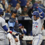 
              Toronto Blue Jays' George Springer, center, celebrates with teammate Ric Tapia (15) after hitting a two-run home run against the Tampa Bay Rays during the third inning of a baseball game Sunday, Sept. 25, 2022, in St. Petersburg, Fla. (AP Photo/Scott Audette)
            