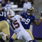 
              Washington quarterback Michael Penix Jr. attempts a pass while being pressured by Stanford defensive end Stephen Herron Jr. during the first half of an NCAA college football game Saturday, Sept. 24, 2022, in Seattle. (AP Photo/Stephen Brashear)
            