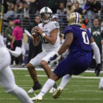 against Michigan State quarterback Payton Thorne (10) looks to pass against Washington defensive lineman Sav'ell Smalls (0) during the first half of an NCAA college football game, Saturday, Sept. 17, 2022, in Seattle. (AP Photo/Stephen Brashear)
