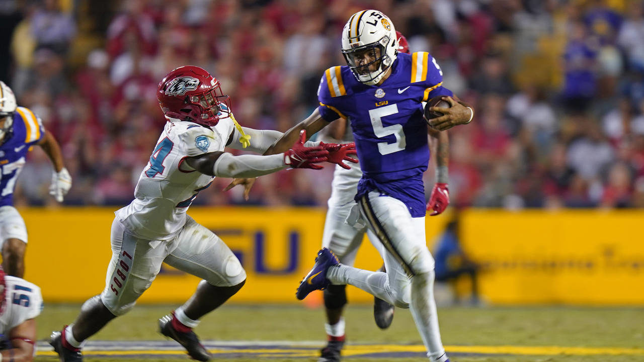LSU quarterback Jayden Daniels (5) carries against New Mexico safety AJ Haulcy (24) in the second h...