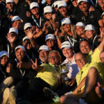 
              Bob MacIntyre of Scotland, holding the trophy he jus won, poses for a photo with volunteers of the Italian Open golf tournament in Guidonia Montecelio, near Rome, Italy, Sunday, Sept. 18, 2022. The Italian Open took place on the Marco Simone course that will host the 2023 Ryder Cup. (AP Photo/Alessandra Tarantino)
            