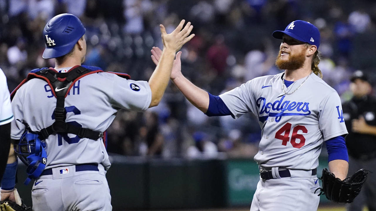 Los Angeles Dodgers relief pitcher Craig Kimbrel (46) slaps hands with catcher Will Smith after the...