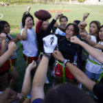 
              Elsa Morin, 17, center right, leads a chant as Redondo Union High School girls try out for a flag football team on Thursday, Sept. 1, 2022, in Redondo Beach, Calif. Southern California high school sports officials will meet on Thursday, Sept. 29, to consider making girls flag football an official high school sport. This comes amid growth in the sport at the collegiate level and a push by the NFL to increase interest. (AP Photo/Ashley Landis)
            