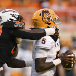 Oklahoma State defensive end Collin Oliver (30) sacks Arizona State quarterback Emory Jones (5) during the first half of an NCAA college football game Saturday, Sept. 10, 2022, in Stillwater, Okla. At left is Arizona State offensive lineman Emmit Bohle.(AP Photo/Brody Schmidt)