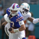 
              Miami Dolphins defensive end Emmanuel Ogbah (91) grabs Buffalo Bills quarterback Josh Allen (17) during the first half of an NFL football game, Sunday, Sept. 25, 2022, in Miami Gardens, Fla. (AP Photo/Rebecca Blackwell)
            