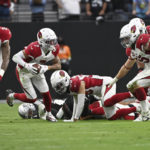 
              Arizona Cardinals cornerback Byron Murphy Jr. (7) picks up a fumble and returns it for the game-winning touchdown during overtime of an NFL football game against the Las Vegas Raiders Sunday, Sept. 18, 2022, in Las Vegas. Arizona won 29-23. (AP Photo/David Becker)
            