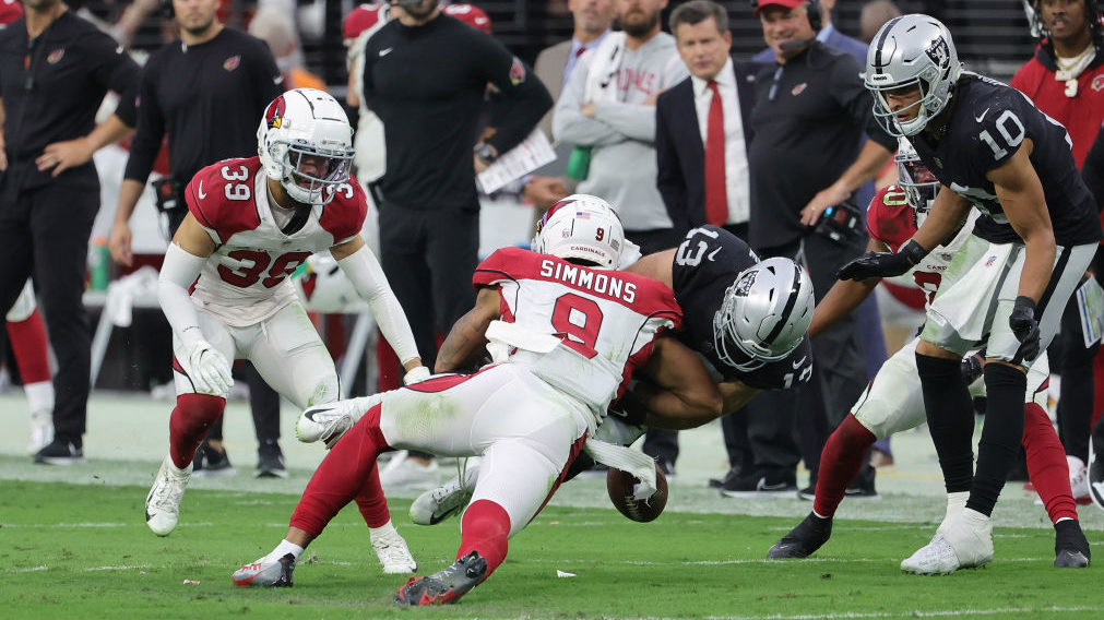 Isaiah Simmons #9 of the Arizona Cardinals forces Hunter Renfrow #13 of the Las Vegas Raiders to fu...