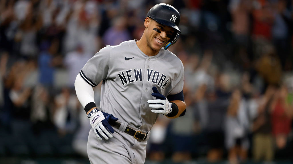 Aaron Judge #99 of the New York Yankees smiles as he rounds the bases after hitting his 62nd home r...