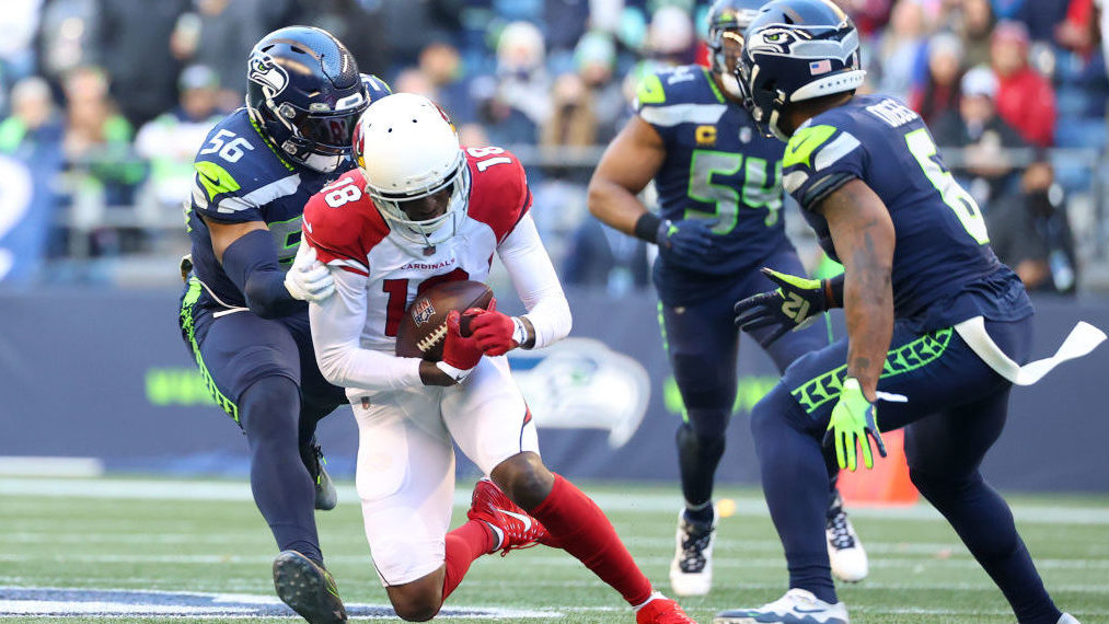 A.J. Green #18 of the Arizona Cardinals is tackled by Jordyn Brooks #56 of the Seattle Seahawks aft...