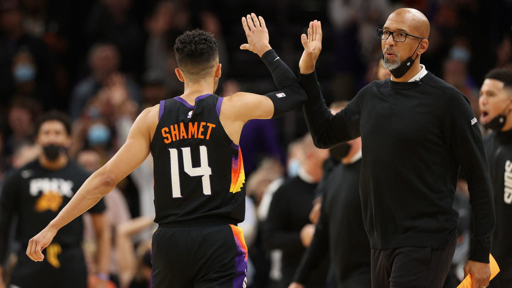 Head coach Monty Williams of the Phoenix Suns high-fives Landry Shamet #14 after a three-point shot...