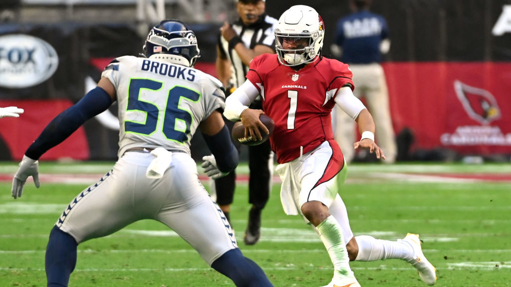 Kyler Murray #1 of the Arizona Cardinals runs the ball in front of Jordyn Brooks #56 of the Seattle...