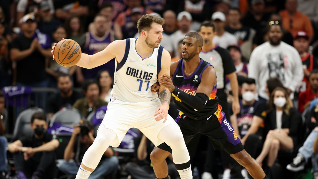 Luka Doncic #77 of the Dallas Mavericks handles the ball against Chris Paul #3 of the Phoenix Suns ...