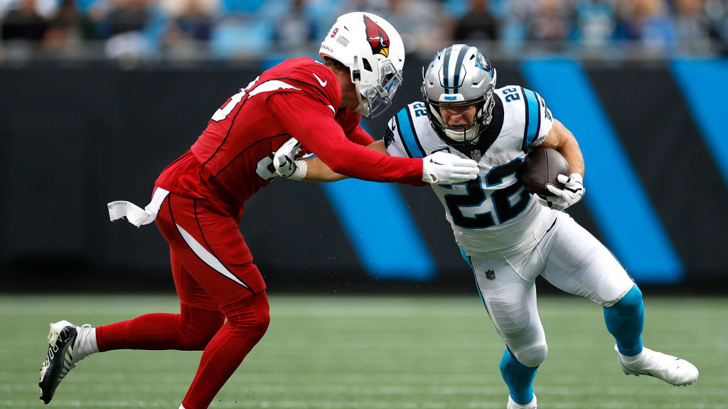 Christian McCaffrey #22 of the Carolina Panthers runs with the ball against Nick Vigil #59 of the A...