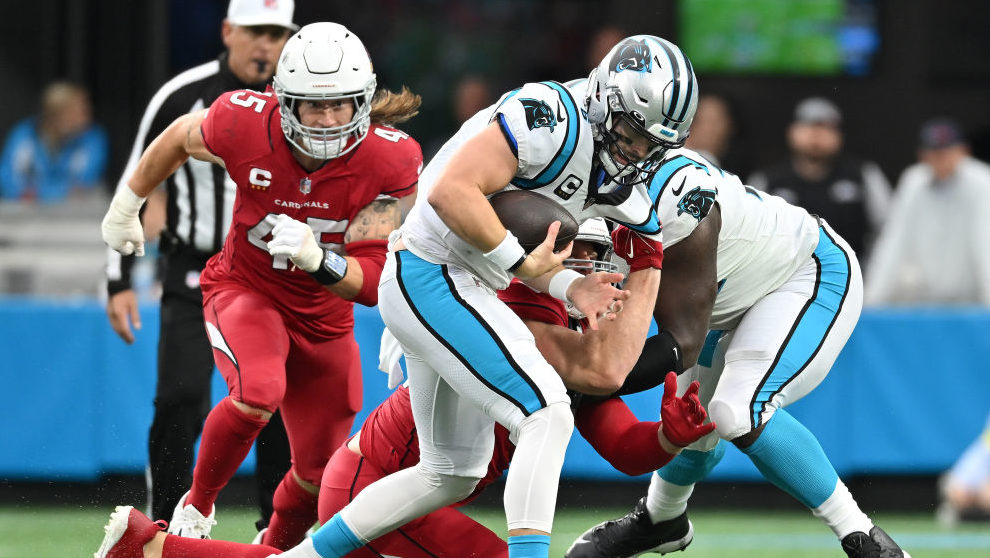 Baker Mayfield #6 of the Carolina Panthers runs with the ball against Zach Allen #94 of the Arizona...