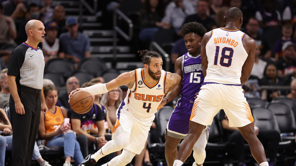 Duane Washington Jr. #4 of the Phoenix Suns handles the ball against Davion Mitchell #15 of the Sac...