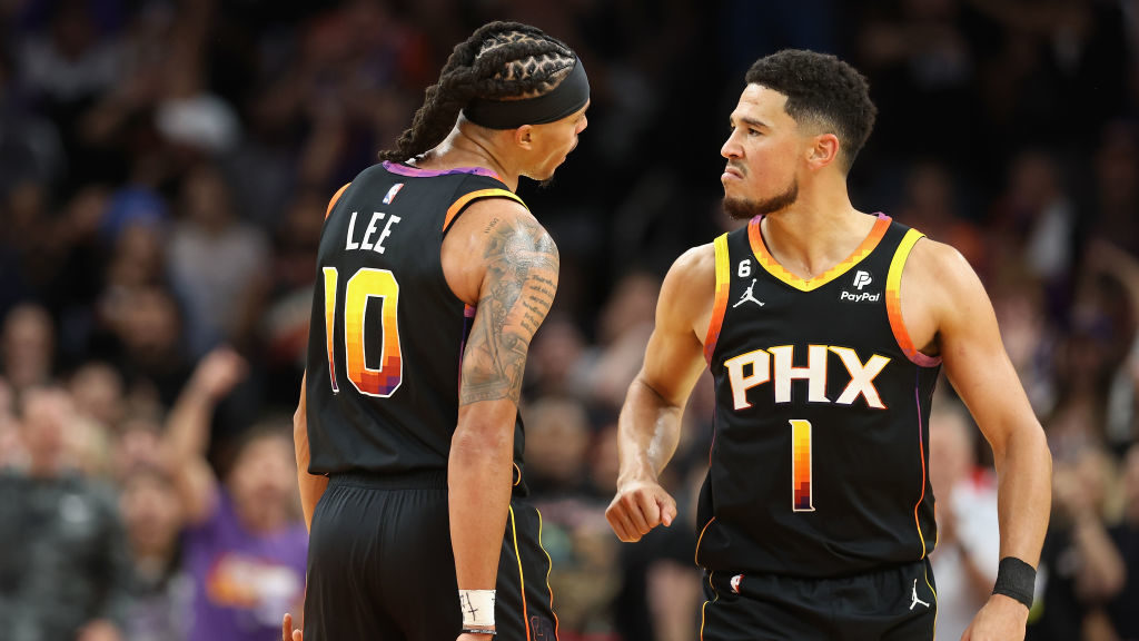 Damion Lee #10 of the Phoenix Suns celebrates with Devin Booker #1 after scoring against the Dallas...