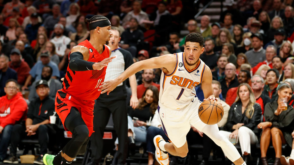 Devin Booker #1 of the Phoenix Suns dribbles against the Portland Trail Blazers during the first qu...