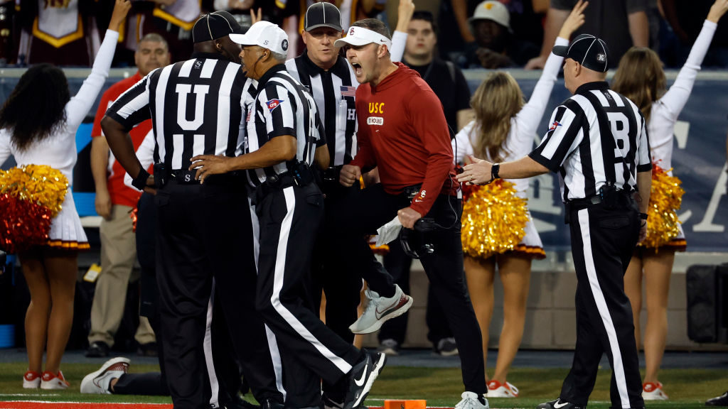 Head coach Lincoln Riley of the USC Trojans talks to referee Michael Mothershed during the first ha...