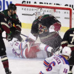 Alexis Lafrenière #13 of the New York Rangers crashes into goaltender Connor Ingram #39 of the Arizona Coyotes as he scores a goal during the second period of the NHL game at Mullett Arena on October 30, 2022 in Tempe, Arizona. (Photo by Christian Petersen/Getty Images)