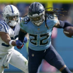 Tennessee Titans running back Derrick Henry (22) runs with the ball as Indianapolis Colts safety Julian Blackmon (32) defends during the second half of an NFL football game Sunday, Oct. 23, 2022, in Nashville, Tenn. (AP Photo/Mark Humphrey)